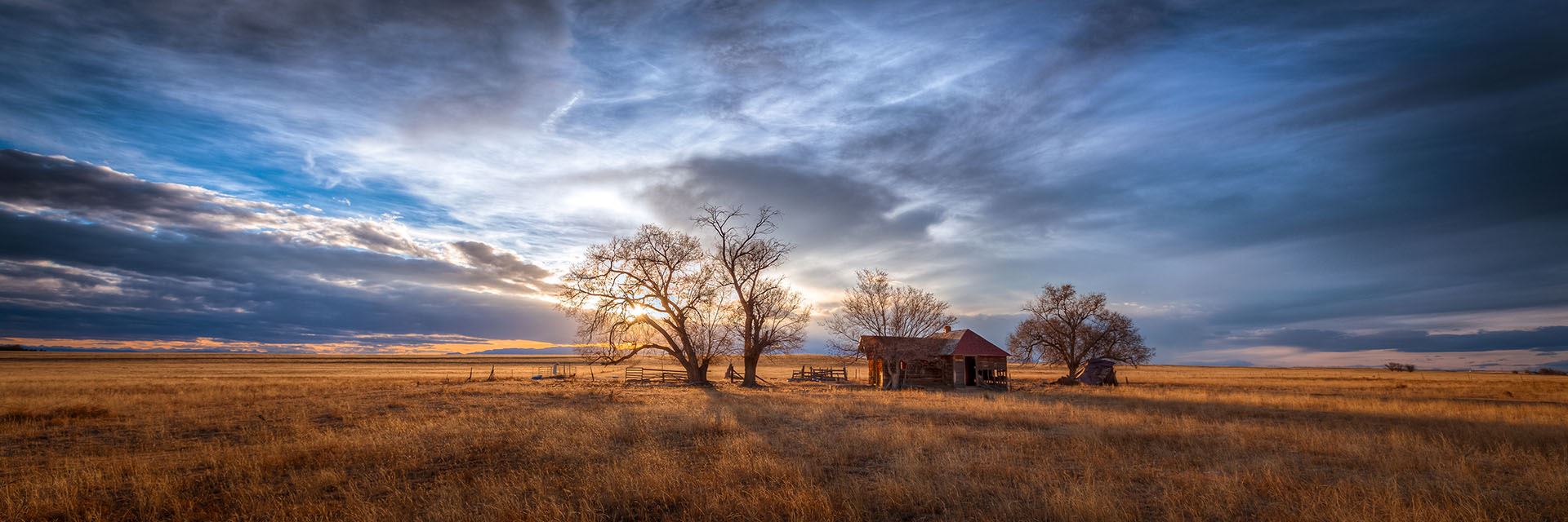farm house in the middle of a prairie 